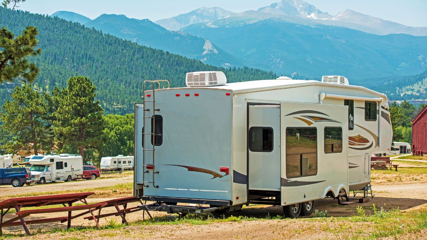 RV driving along I-90 with mountains in the distance